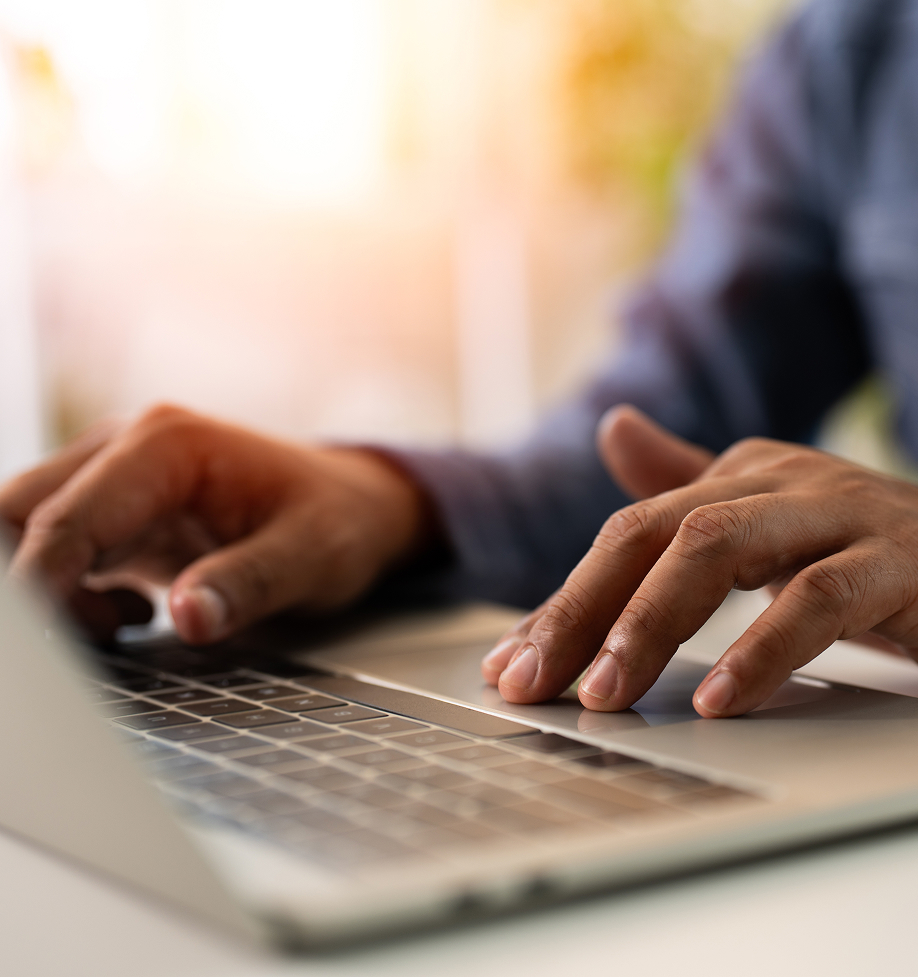 Close up of someone typing on a keyboard on a laptop.